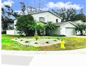 Beautifully landscaped front yard featuring a lush green lawn and ornamental plants at 1309 Harms Way, Port Orange, FL 32129