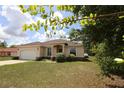 Attractive single-story home with a manicured front lawn and a two-car garage at 13157 Sw 35Th Cir, Ocala, FL 34473