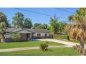 Inviting single-story home with a well-maintained lawn, mature trees, and a classic design at 1326 W Concord St, Orlando, FL 32805