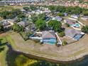 Aerial view of the home, showcasing the pool, lake, and community surroundings at 134 Foggy Creek Ct, Davenport, FL 33837