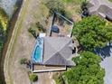 Overhead perspective of the property featuring a screened pool and lake view at 134 Foggy Creek Ct, Davenport, FL 33837