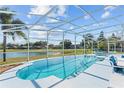 Inviting screened-in pool area with a view of the lake, perfect for outdoor relaxation at 134 Foggy Creek Ct, Davenport, FL 33837