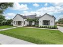 Eye-catching exterior view of a modern home with manicured lawn and a paver driveway at 1400 Nottingham St, Orlando, FL 32803