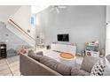 The spacious living room features a vaulted ceiling, staircase, large windows, and tile flooring at 1415 Sherbourne St, Winter Garden, FL 34787