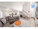 Open-concept living room with tile flooring, a staircase, and flowing access to the kitchen at 1415 Sherbourne St, Winter Garden, FL 34787