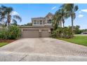 Attractive two-story home, featuring an attached three-car garage and lush landscaping at 14315 Hampshire Bay Cir, Winter Garden, FL 34787