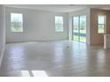 Spacious room with tile floors, large windows, and sliding doors offering natural light and outdoor access at 14647 Crestavista Dr, Clermont, FL 34714