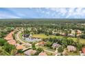 Aerial view showcasing the home's location on a picturesque lot with pond views and lush landscaping at 1518 Shadowmoss Cir, Lake Mary, FL 32746