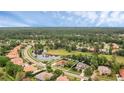 Aerial view showcasing the home's location on a picturesque lot with pond views and lush landscaping at 1518 Shadowmoss Cir, Lake Mary, FL 32746