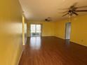 Bright living room featuring tile flooring, ample natural light, and ceiling fans at 1705 Betrillo Ct, The Villages, FL 32162