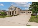 Spacious driveway leading to a three-car garage with a well-maintained lawn at 1710 Alejo Dr, Apopka, FL 32712