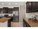 Modern kitchen with dark cabinets, granite countertops, and stainless steel appliances at 1710 Alejo Dr, Apopka, FL 32712