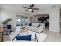 Bright living room featuring neutral tones, tile floors, and sliding glass doors to a patio at 1710 Alejo Dr, Apopka, FL 32712