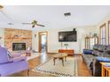 Cozy living room with a brick fireplace and comfortable seating arrangement at 2102 E Atmore Cir, Deltona, FL 32725