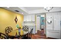 Kitchen features a round dining table, quartz countertops, white appliances, white cabinets, and hardwood floors at 222 Paul Mcclure Ct, Casselberry, FL 32707