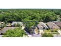 Aerial view of a property with mature trees and surrounding neighborhood homes at 2515 Wekiva Walk Way, Apopka, FL 32703