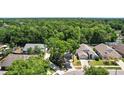 Aerial view of a charming home with mature trees and surrounding neighborhood at 2515 Wekiva Walk Way, Apopka, FL 32703
