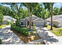 Charming home with well-manicured landscaping, mature trees, and a spacious driveway at 2515 Wekiva Walk Way, Apopka, FL 32703