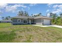 Inviting single-Gathering home featuring a well-maintained lawn, spacious driveway, and an attached two-car garage at 2808 Sw 139Th St, Ocala, FL 34473