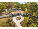 An elevated shot of the home showing the grounds, the circular drive, and the manicured lawn at 2945 Southgate Ter, Orlando, FL 32818