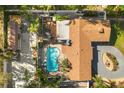 An aerial view of the backyard, pool, deck, cabana, and brown shingled roof at 2945 Southgate Ter, Orlando, FL 32818