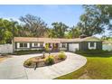 Charming single story home featuring a circular driveway and well-manicured front yard at 2945 Southgate Ter, Orlando, FL 32818