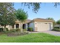 Charming single-story home with tile roof, stone accents, well-manicured lawn and brick paver driveway at 307 Monterey St, Kissimmee, FL 34759