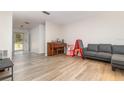 Bright living room with hardwood floors and neutral paint, providing a clean and open space at 360 Westchester Dr, Deland, FL 32724