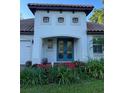 Close up of the home's entrance with a red flower bed in front of the double door at 3609 Azurite Ct, Deland, FL 32724