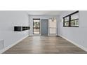 Bright, open living room featuring new floors, modern lighting, and large windows at 451 Hibiscus Rd, Casselberry, FL 32707