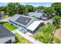 Aerial view of home showing roof, solar panels, fenced backyard, and screened patio at 578 Darkwood Ave, Ocoee, FL 34761