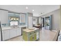 Bright kitchen with white cabinets, stainless steel appliances, and center island at 578 Darkwood Ave, Ocoee, FL 34761