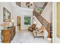 Grand foyer with staircase, tile flooring, and sitting area, offering a welcoming entrance at 755 Cranes Court, Maitland, FL 32751