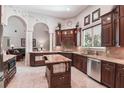 Gourmet kitchen with island, granite countertops, custom cabinets, and stainless appliances at 755 Cranes Court, Maitland, FL 32751