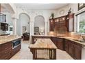 Gourmet kitchen with island, granite countertops, custom cabinets, and open floor plan for entertaining at 755 Cranes Court, Maitland, FL 32751