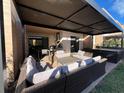 Beautiful covered patio with comfortable seating, a grill, and a hot tub for relaxing and entertaining at 7567 Brooklyn Dr, Kissimmee, FL 34747
