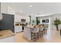Open-concept kitchen featuring granite countertops, stainless steel appliances, and a center island with seating at 786 Mocking Jay Ln, St Cloud, FL 34771