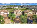 An aerial view showcases a residential neighborhood with well-manicured lawns and tile roofs at 8961 Rhodes St, Kissimmee, FL 34747