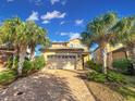 Charming two-story home with well-maintained landscaping and a spacious two car garage at 8961 Rhodes St, Kissimmee, FL 34747