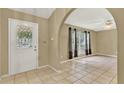 Bright living room featuring tile flooring, neutral walls, and large windows with backyard views at 9290 Lake Sharp Ct, Orlando, FL 32817
