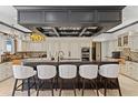 Bright gourmet kitchen features a large island with seating, pendant lighting, and custom cabinetry at 9624 Bryanston Dr, Orlando, FL 32827