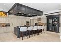 Custom gourmet kitchen with a large center island, breakfast bar, and wine fridge at 9624 Bryanston Dr, Orlando, FL 32827