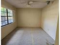 Cozy bedroom featuring a window for natural light and neutral walls at 9741 Se Highway 464C Se Hwy, Ocklawaha, FL 32179