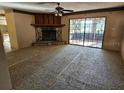 Spacious living room featuring a stone fireplace, ceiling fan, and sliding glass doors to outdoor space at 9741 Se Highway 464C Se Hwy, Ocklawaha, FL 32179
