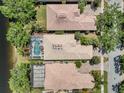 Aerial view of several homes showcasing their barrel tile roofs, screened-in pools, and lush landscaping at 11763 Eagle Ray Ln, Orlando, FL 32827