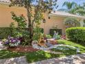 Well-manicured landscaping featuring various plants, colorful flowers, decorative rocks, and lush green grass at 11763 Eagle Ray Ln, Orlando, FL 32827