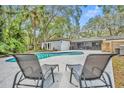 Relaxing poolside with lounge chairs overlooking the pool and lush yard at 1304 Deer Run Dr, Winter Springs, FL 32708