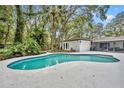 A private backyard oasis with a pool and mature landscaping at 1304 Deer Run Dr, Winter Springs, FL 32708