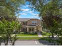 Charming two-story home with a well-maintained lawn and lush landscaping in a desirable neighborhood at 14242 Avenue Of The Groves, Winter Garden, FL 34787