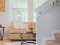 Comfortable living area with sofa, stylish pillows, textured coffee table and natural light from windows at 14242 Avenue Of The Groves, Winter Garden, FL 34787